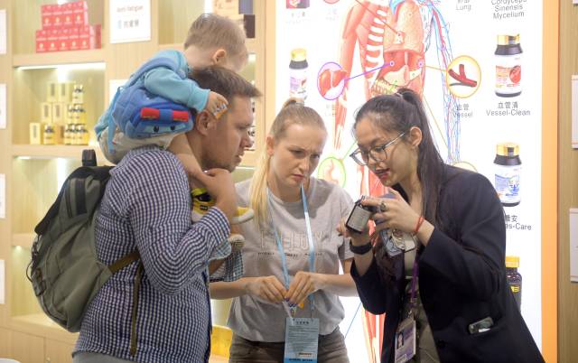 資料圖片：客商在廣交會上參觀選購商品。（新華社發）